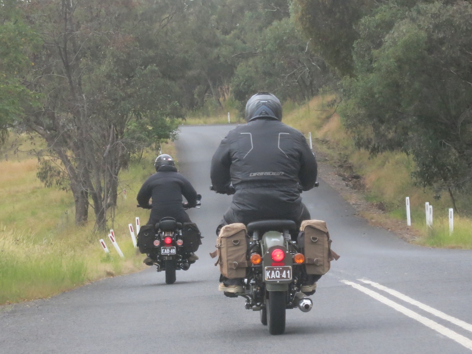 A couple of people ride motorcycles down a road

Description automatically generated with low confidence