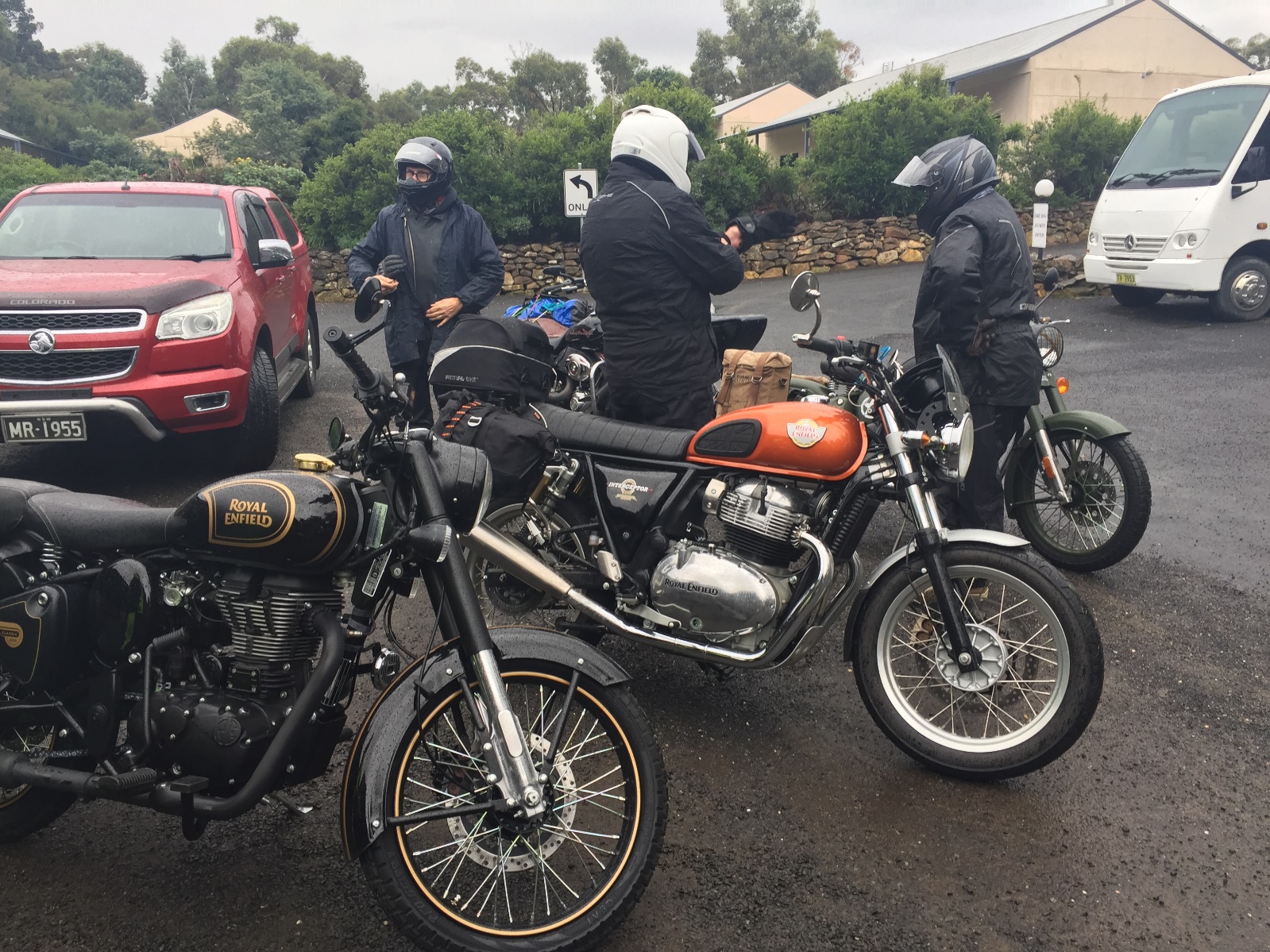 A group of men standing next to motorcycles

Description automatically generated with low confidence