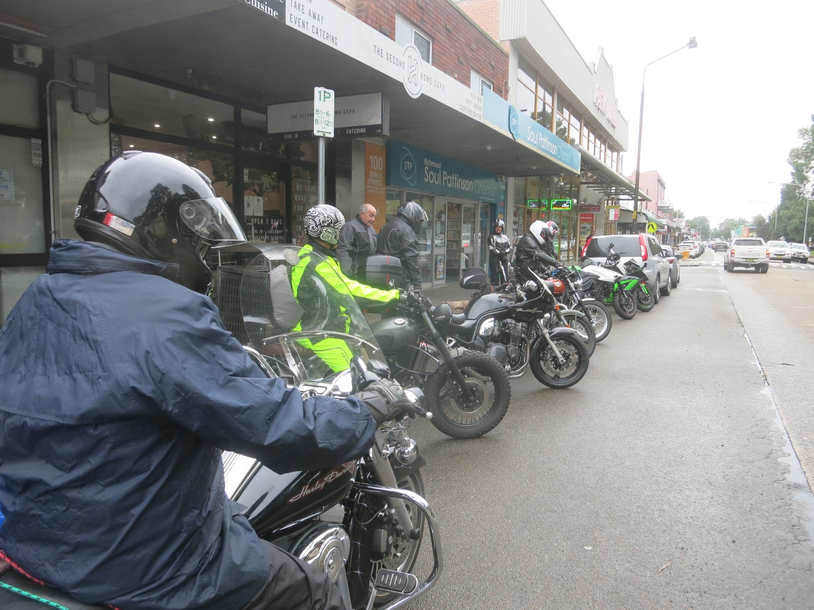 A group of motorcyclists are parked on the side of a street

Description automatically generated with medium confidence