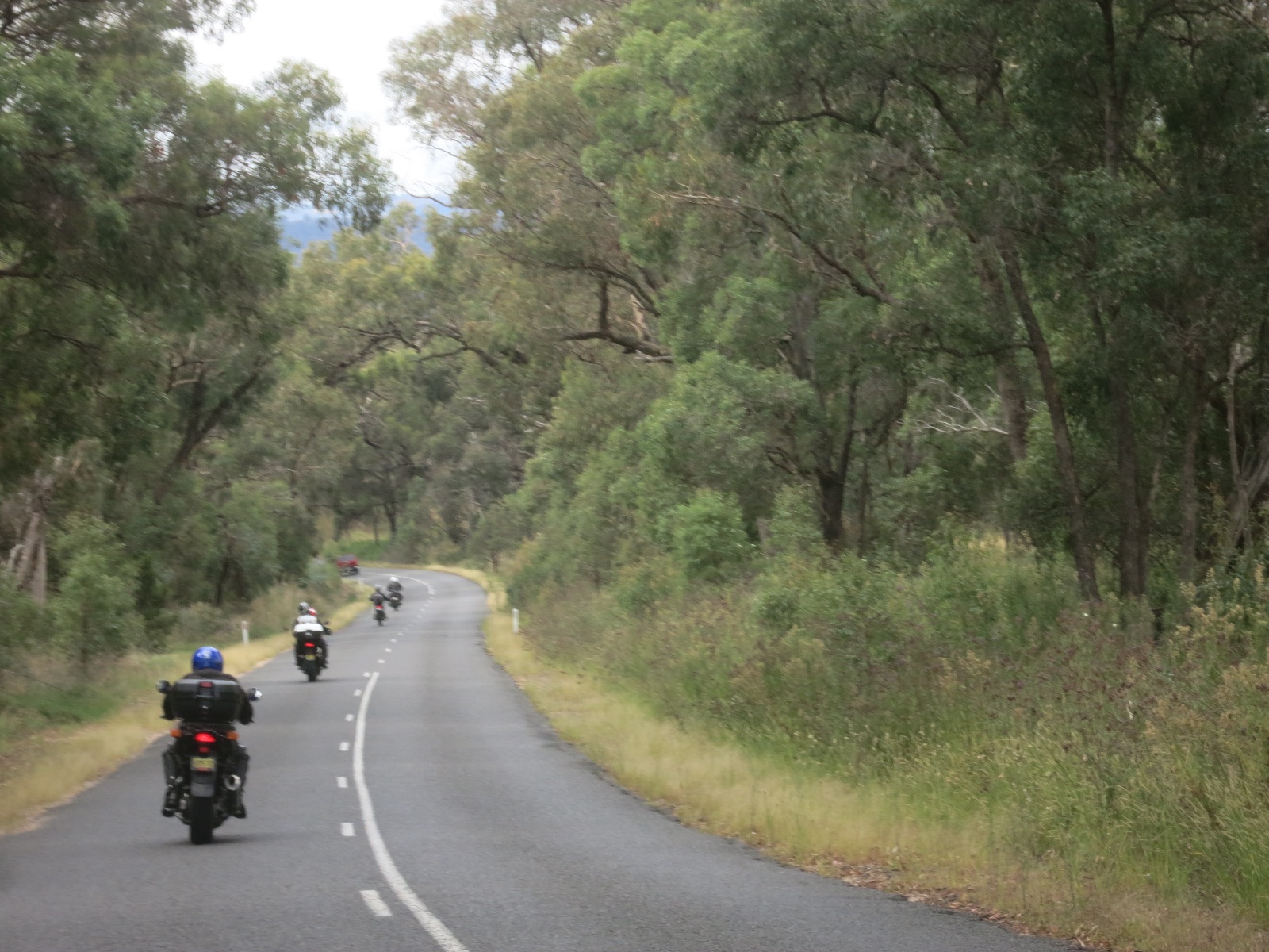 A group of motorcyclists ride down a road

Description automatically generated with medium confidence