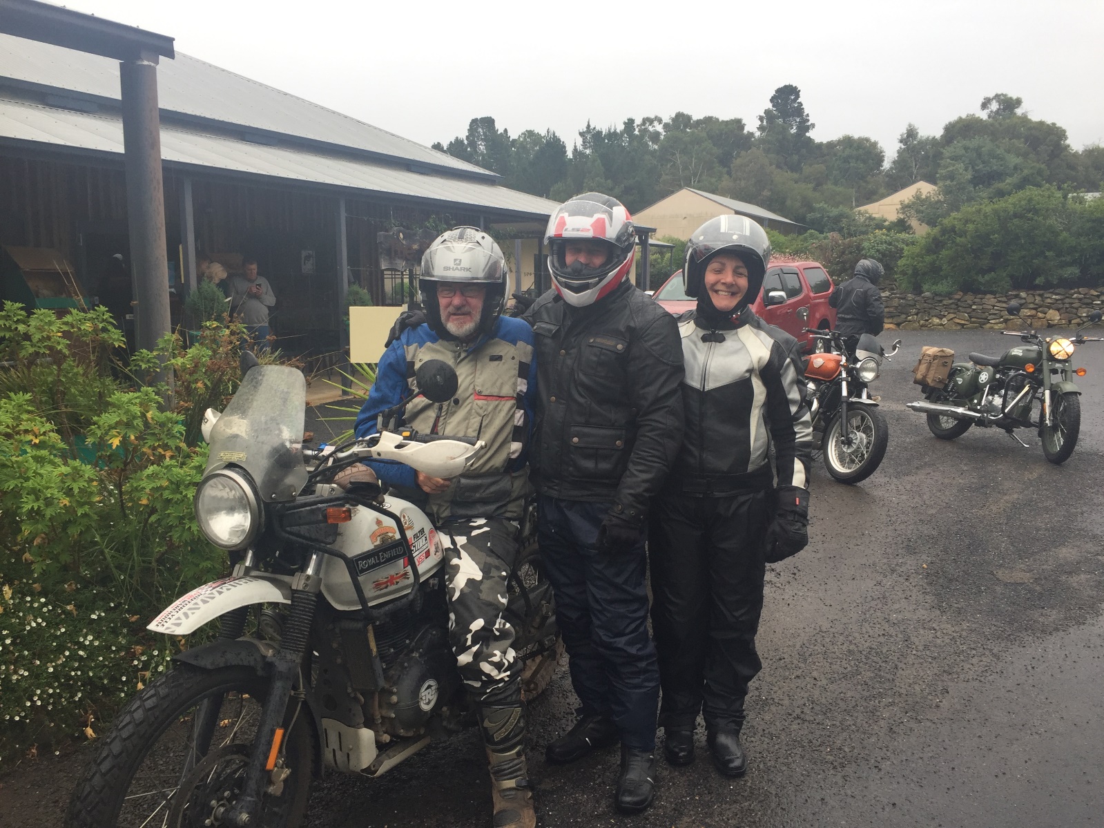 A group of people posing with a motorcycle

Description automatically generated with low confidence
