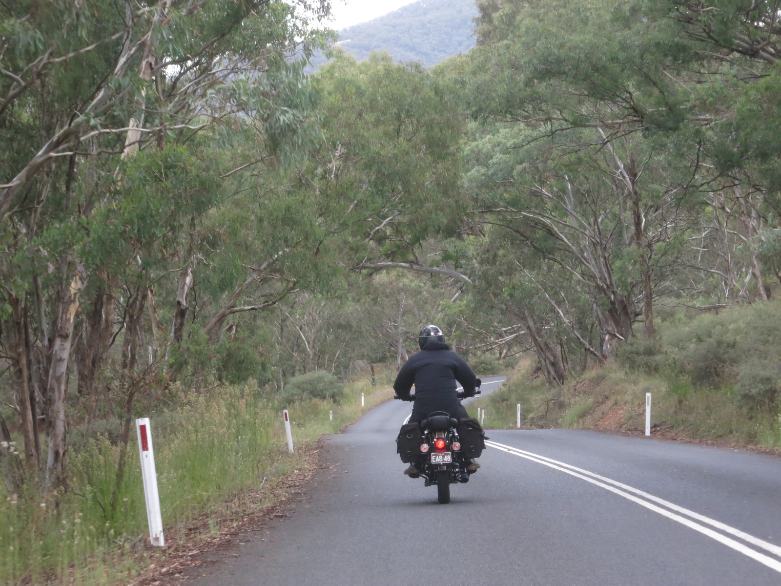A person riding a motorcycle down a road

Description automatically generated with medium confidence