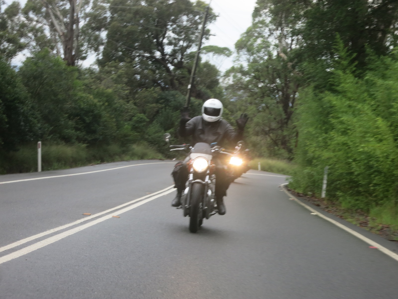 A person riding a motorcycle down the road

Description automatically generated with medium confidence