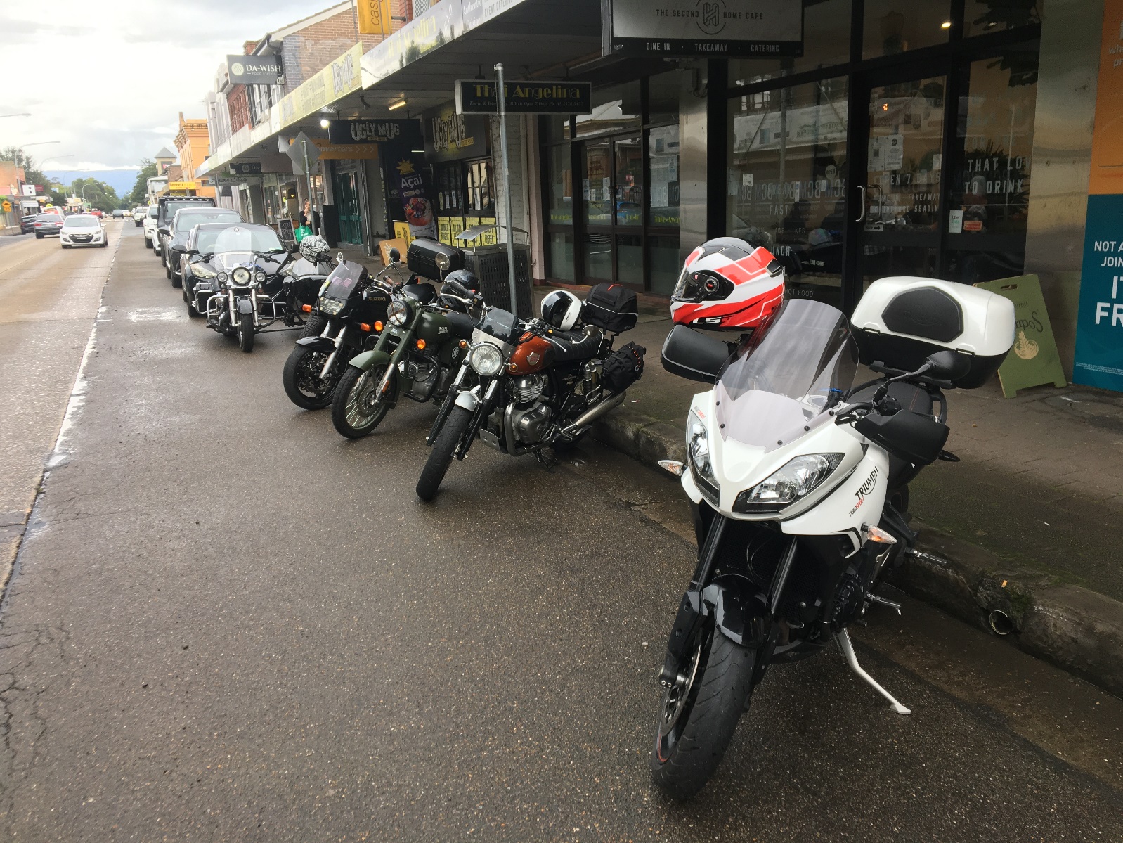 Motorcycles parked on the side of a street

Description automatically generated