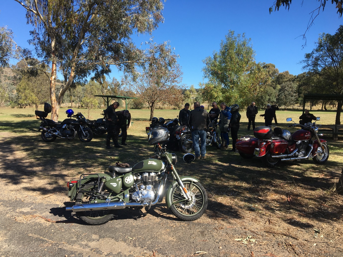 A group of motorcycles parked on the side of a road

Description automatically generated with low confidence
