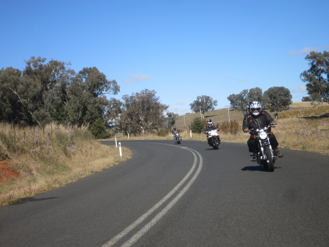 A group of people ride motorcycles down a road

Description automatically generated with medium confidence