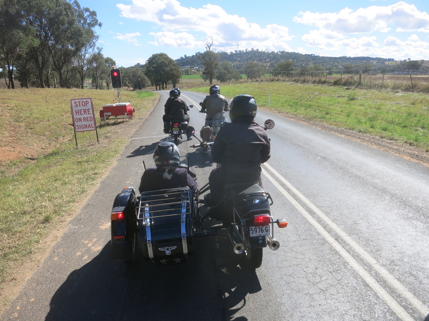 A group of people riding motorcycles on a road

Description automatically generated with medium confidence