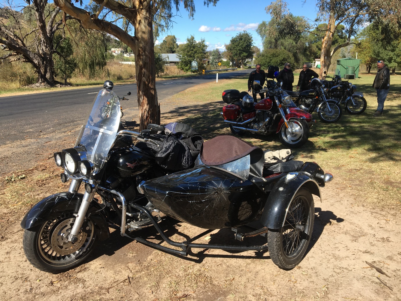A motorcycle parked on the side of the road

Description automatically generated with medium confidence