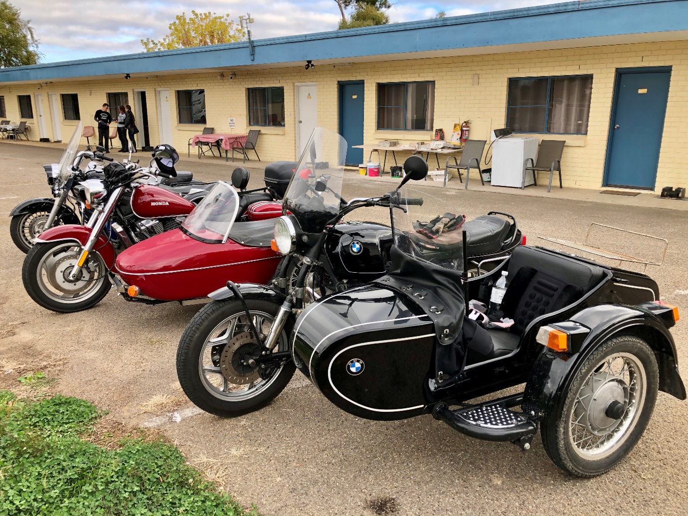 Motorcycles parked in front of a building

Description automatically generated with medium confidence