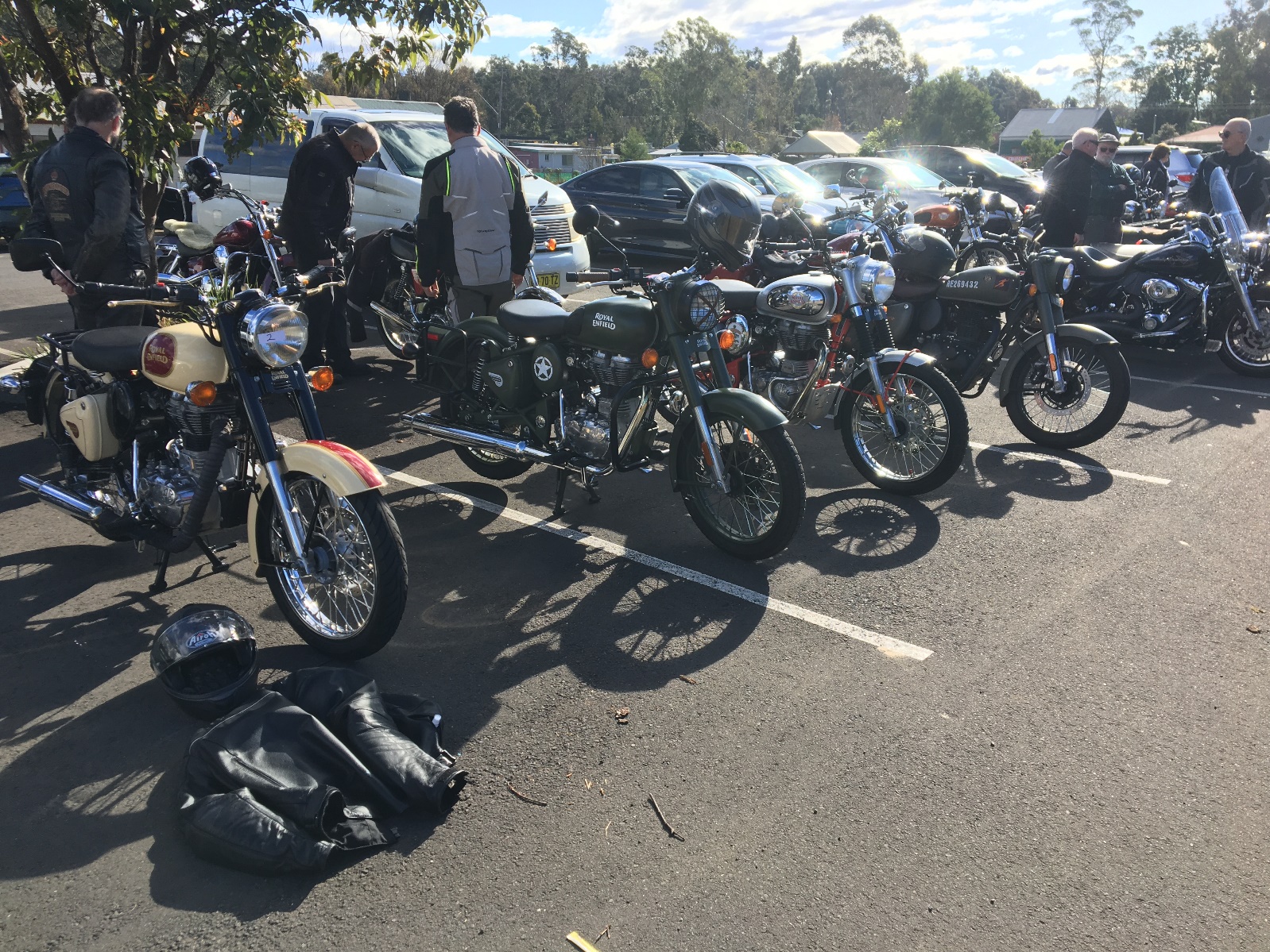 A group of motorcycles parked in a parking lot Description automatically generated with medium confidence