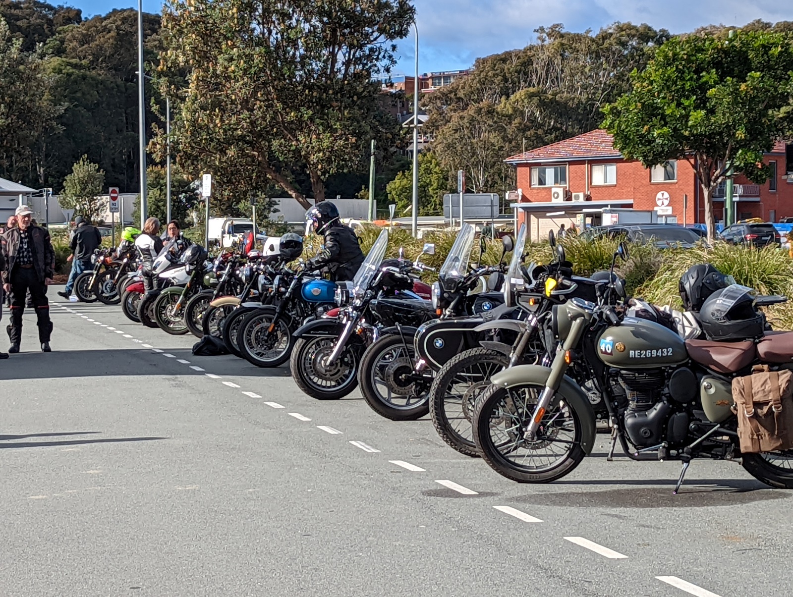 A large group of motorcycles parked on the side of a road Description automatically generated with medium confidence
