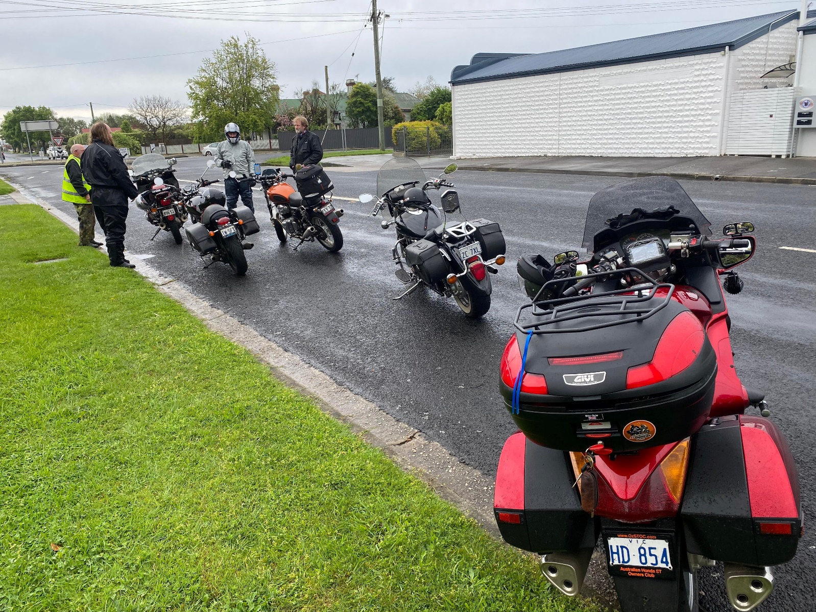 A group of motorcycles parked on the side of a road Description automatically generated with medium confidence